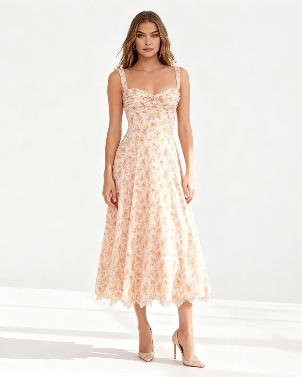 Model wearing the peach midi dress with sweetheart neckline, shown from the front against a white background.