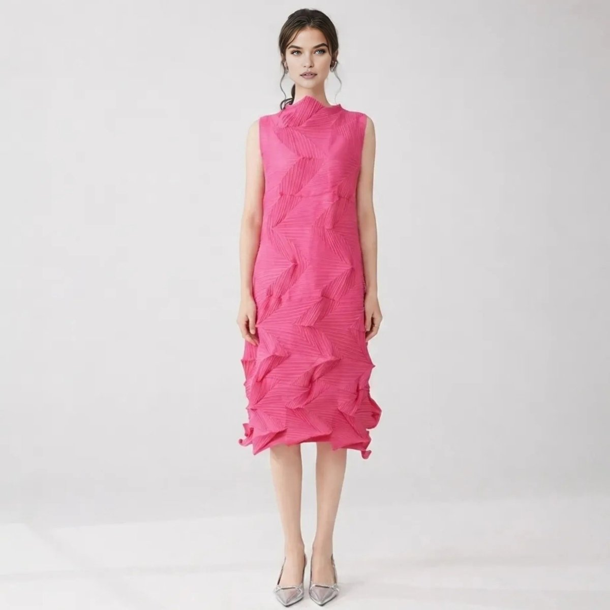Woman wearing pink 3D pleated sleeveless midi dress with high neck looking forward.