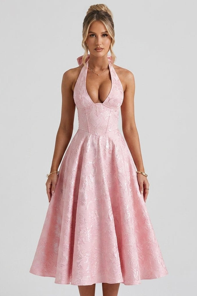 Three quarter angle lifestyle view of pink corset A-line midi dress showcasing plunging neckline and full skirt.