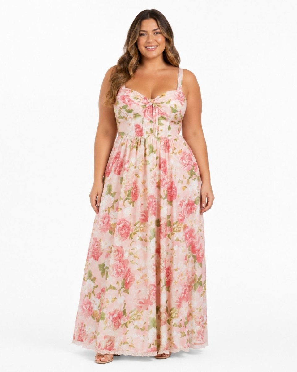 A woman modeling a sleeveless, floor-length floral maxi dress with a sweetheart neckline and tie detail at the bust, set against a plain white studio background.