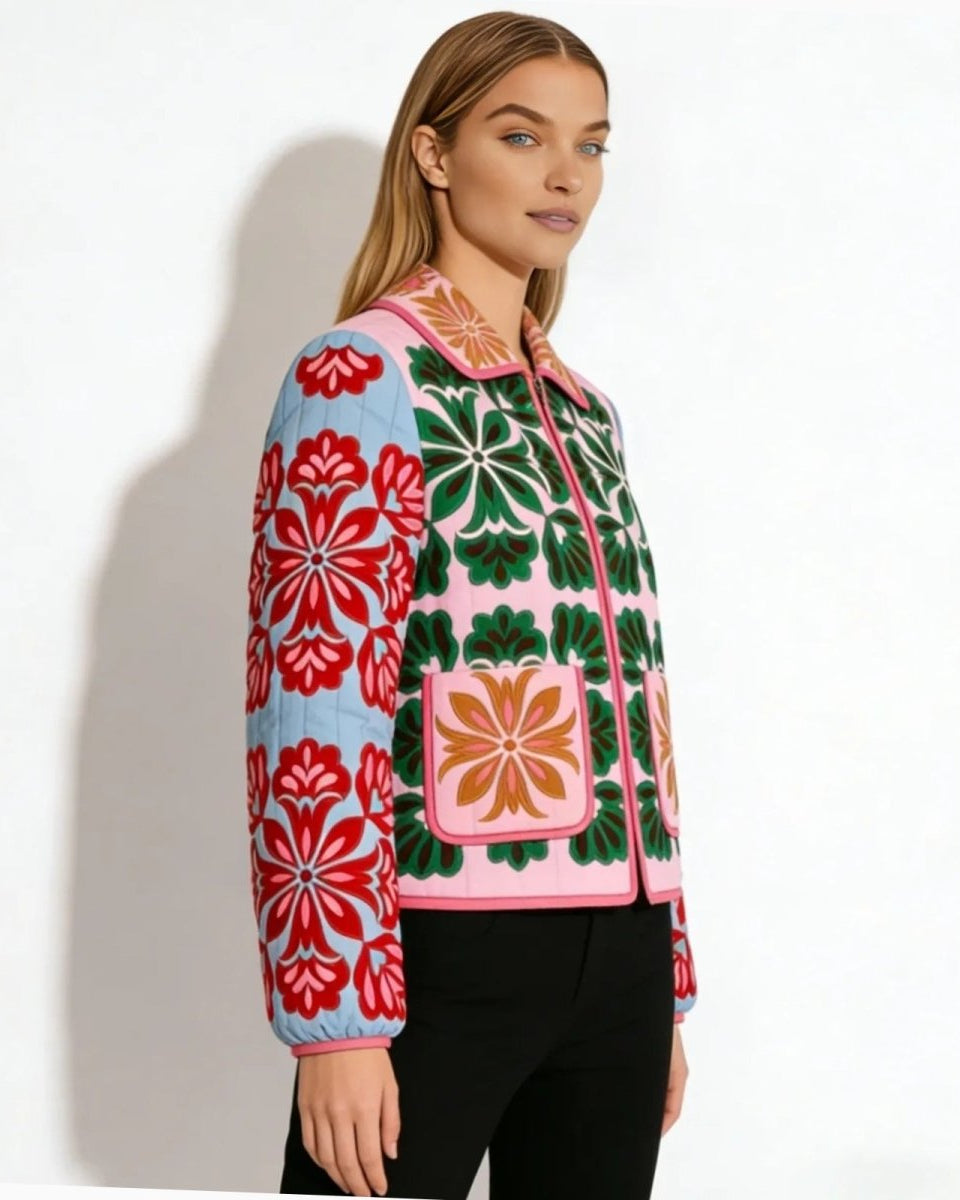 Side view of a woman wearing a colorful quilted floral jacket, showing the contrast between the pink body and the green, red-embroidered sleeves.