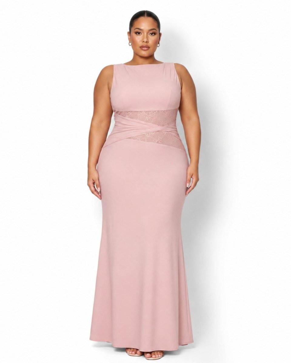 A plus-size model wearing a sleeveless, floor-length dusty pink gown with a sheer lace waist detail, photographed against a plain white studio background.