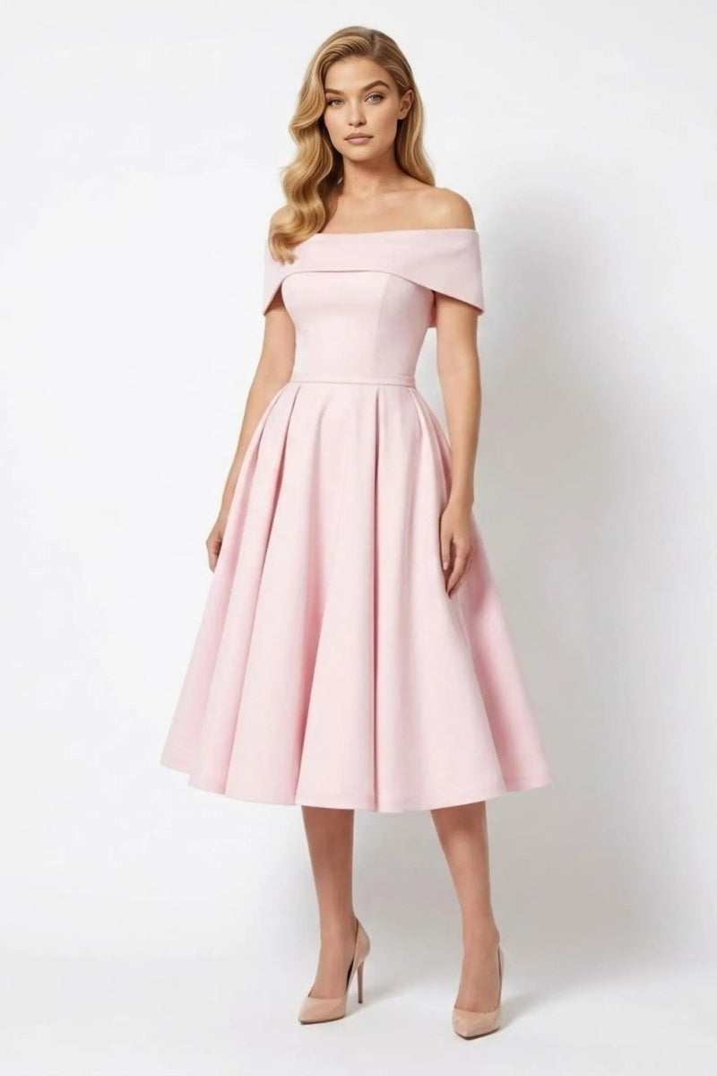 Woman wearing an elegant pink off-the-shoulder A-line midi dress by Kouvr