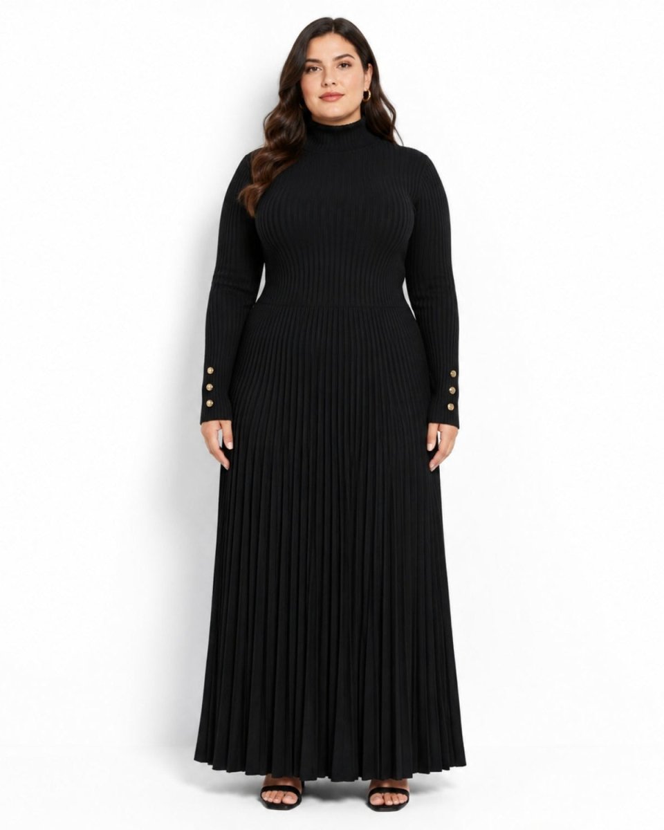 A woman modeling a long-sleeve black ribbed turtleneck maxi dress with pleated detailing and gold button accents on the sleeves, photographed against a plain white studio background.