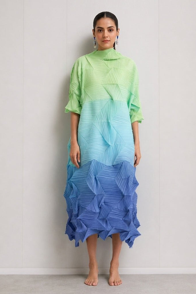 Front view of the Kouvr pleated ombre midi dress in green and blue gradient featuring a high mock neck and 3D geometric texture.