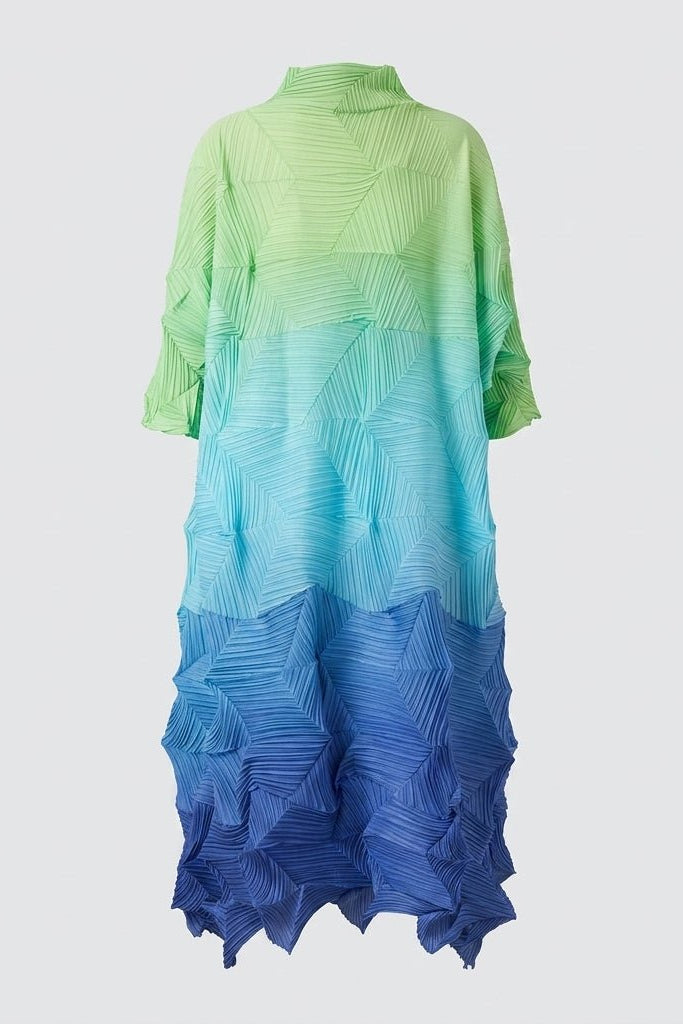 Full length studio shot of the Fenlo Form pleated architectural shift dress highlighting the green, teal, and royal blue color transition.