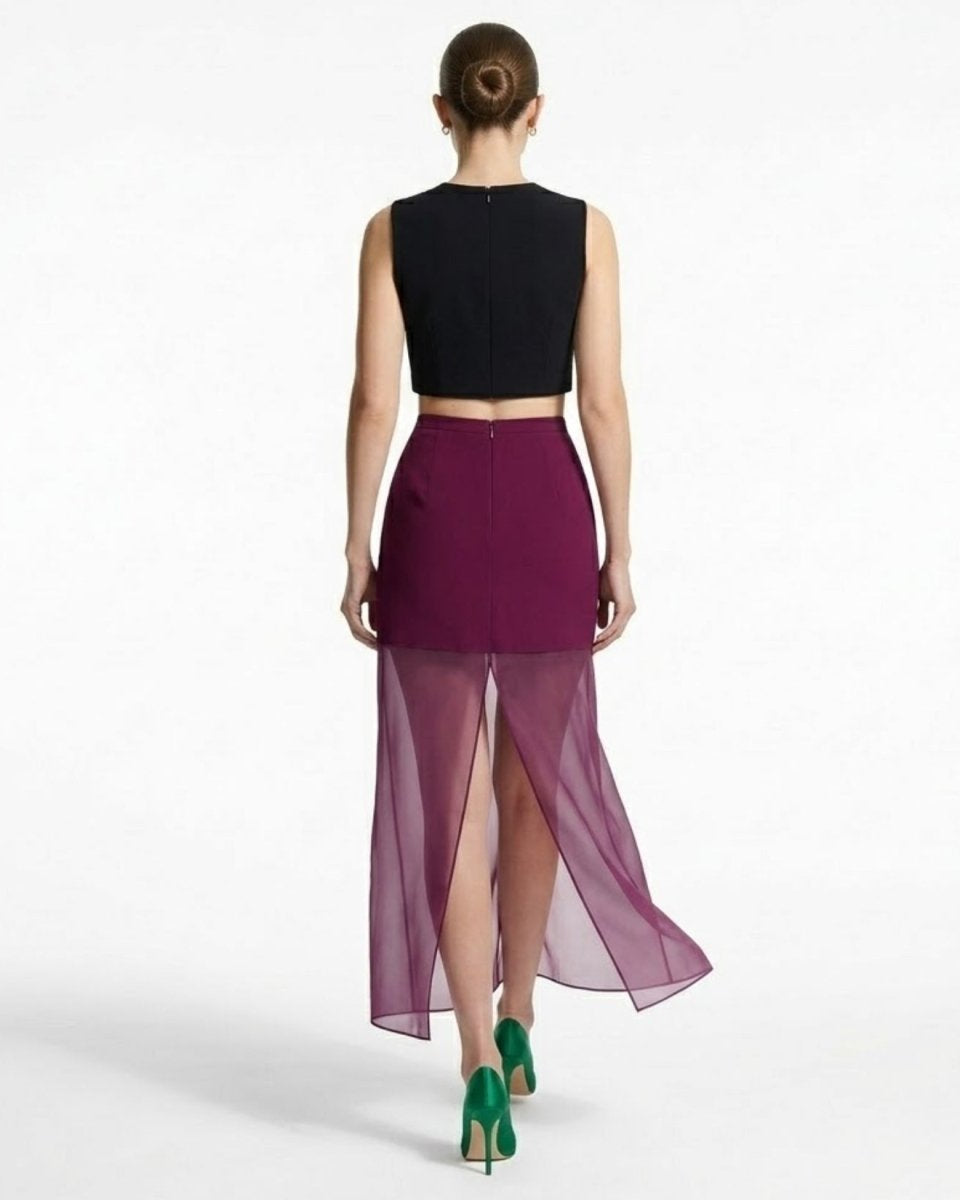 Back view of plum sheer maxi skirt highlighting the invisible center back zipper and high sheer panel slit.