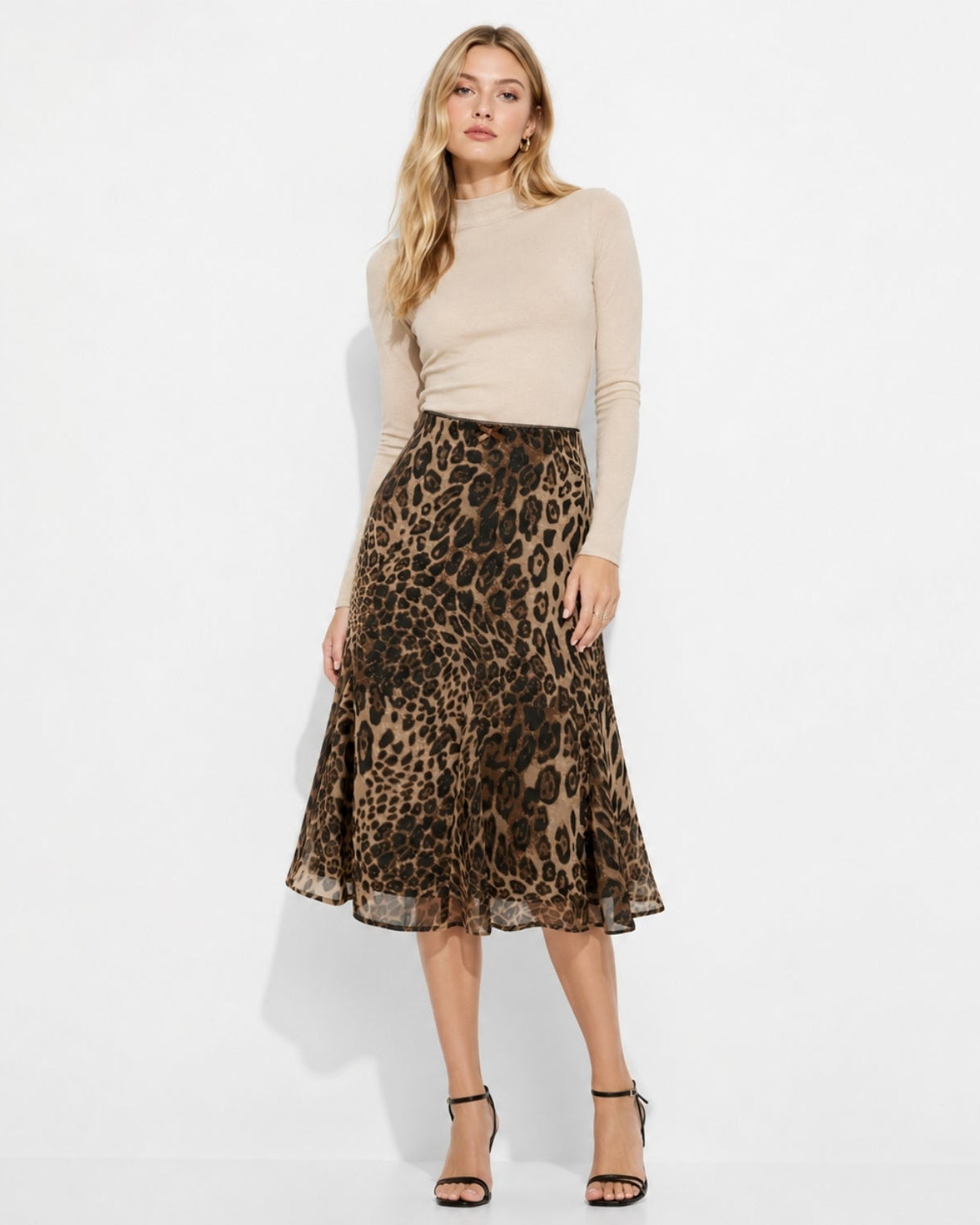 Woman wearing leopard print sheer fluted midi skirt with high waist design