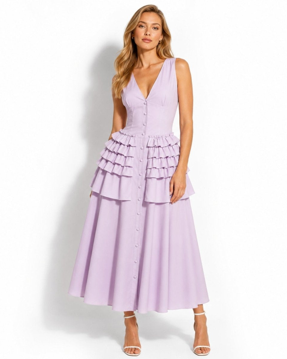 Front view of model wearing luxury purple v-neck tiered ruffle button down midi dress for summer resort wear.