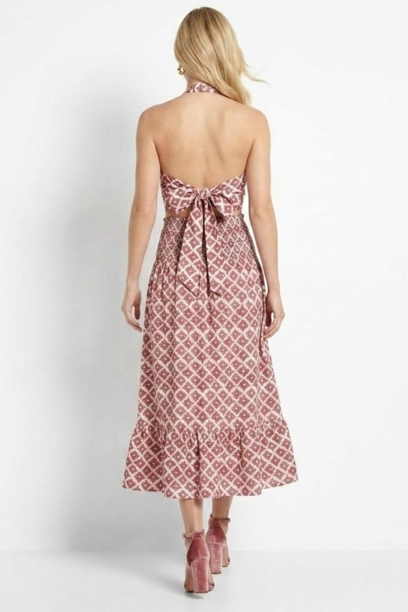Back view of Fenlo Form red boho two piece outfit showing large bow tie top and smocked high waist midi skirt.
