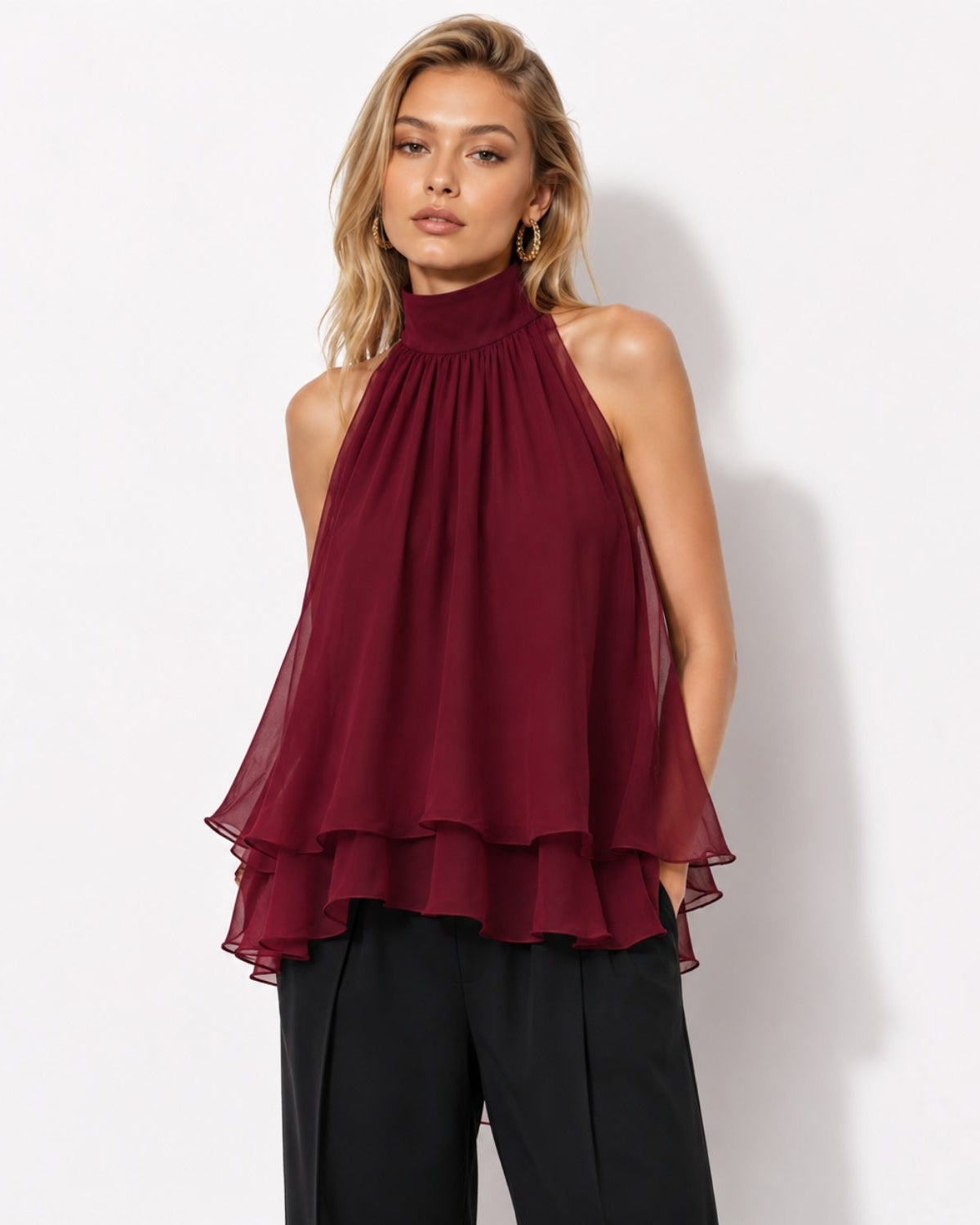 Beautiful woman wearing a deep red red tiered halter neck blouse in semi-sheer chiffon, perfect for luxury evening wear.