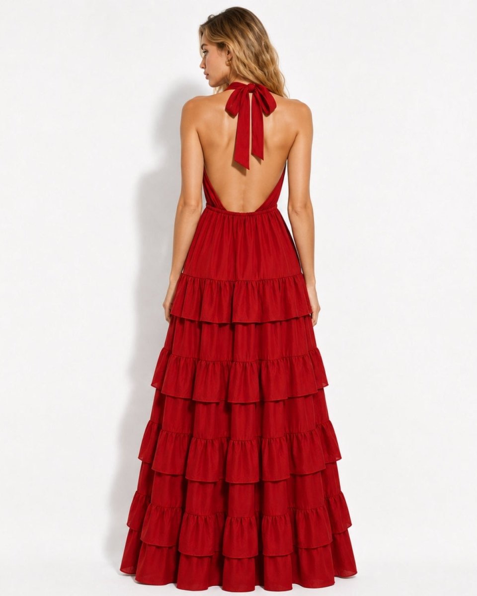 Back view of a red open back tiered maxi dress, highlighting the halter neck tie and floor-length ruffled silhouette.