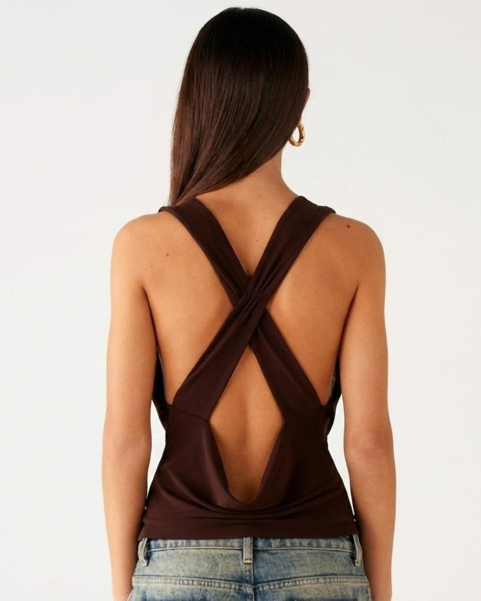 Back view of the Rhea top in dark brown, highlighting the open back with criss-cross strap detail.