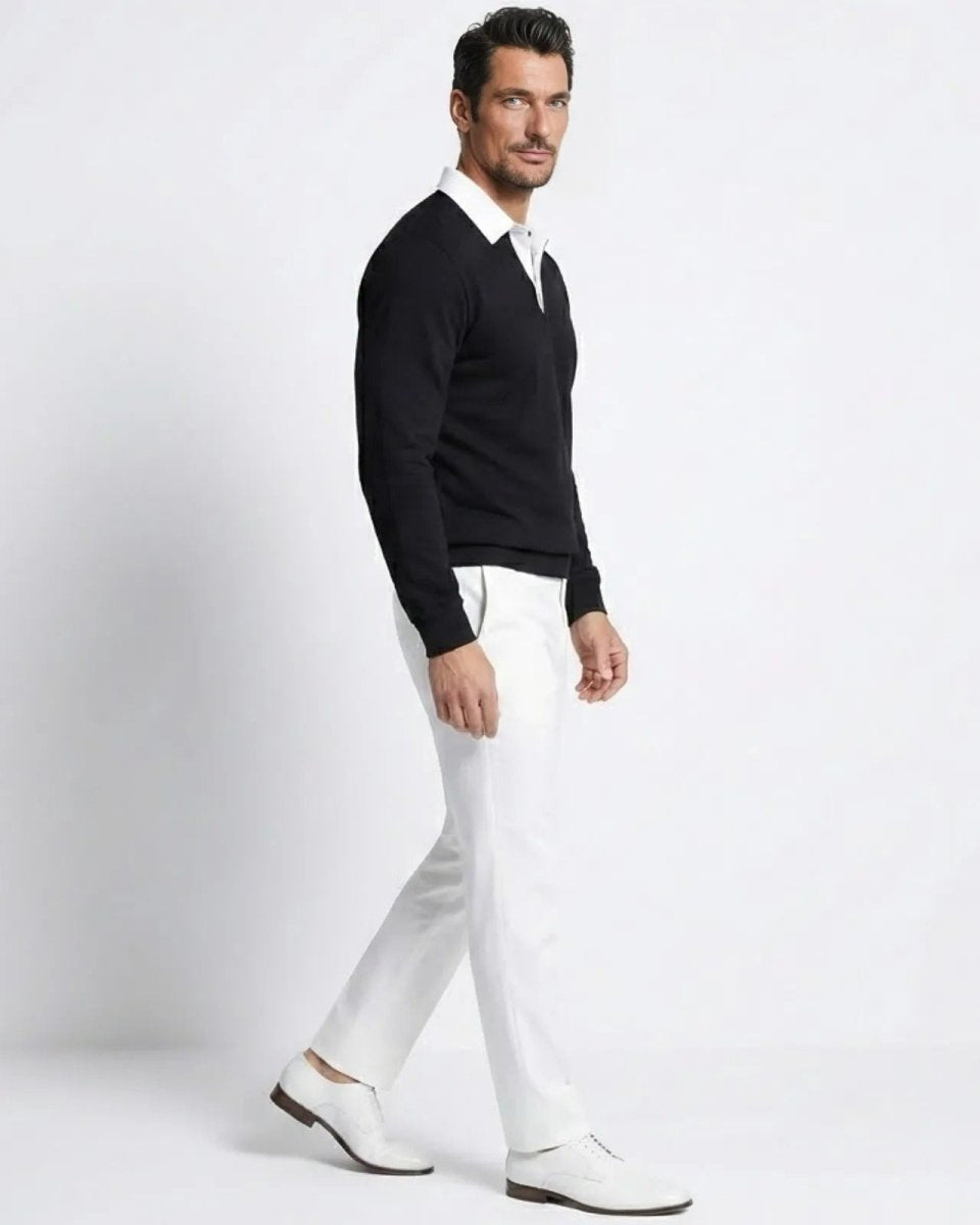Side view of a male model walking in the Rhodes black long sleeve polo sweater, showing the classic fit and drape of the merino-cashmere fabric.