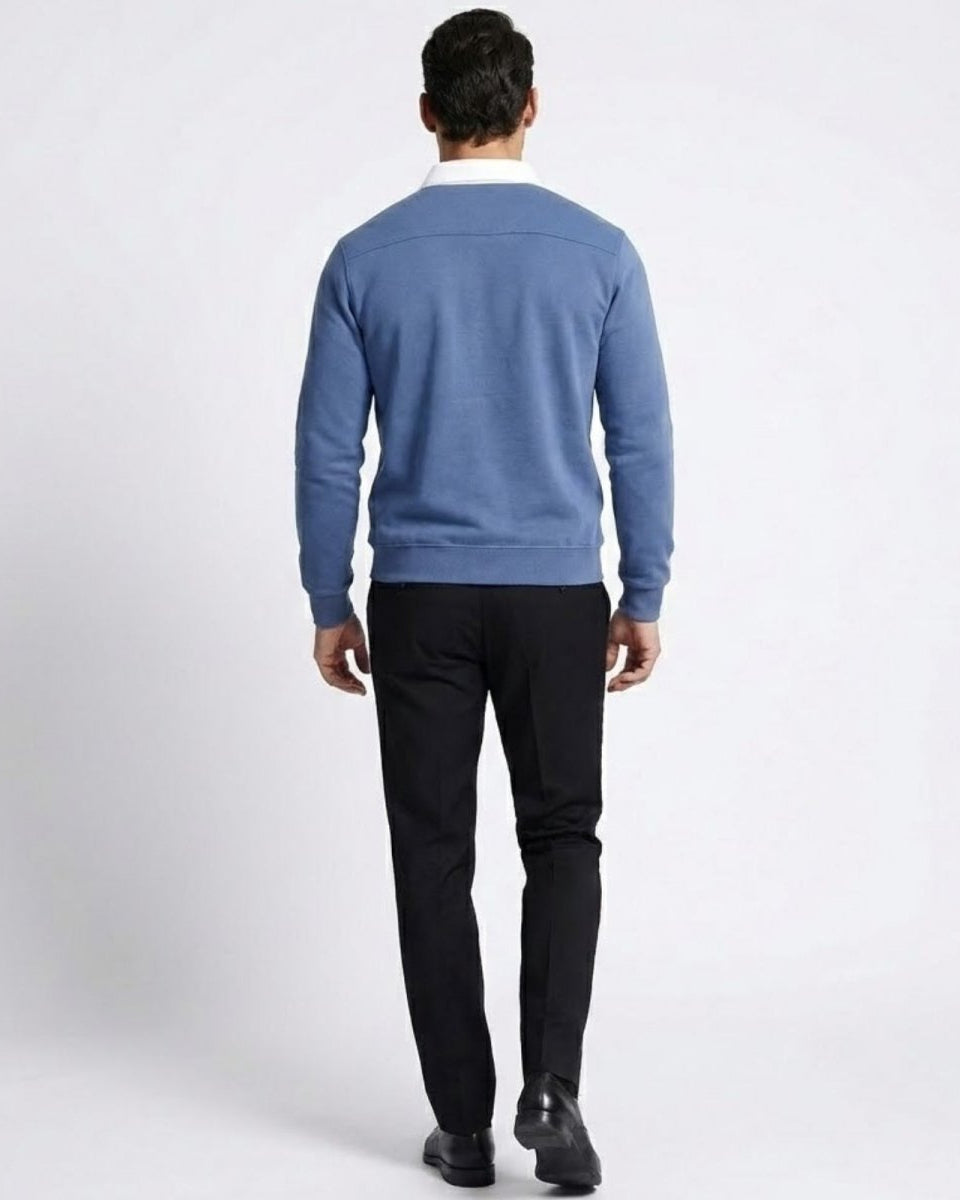 Back view of a man in the Rhodes polo sweater, showing the shoulder yoke detail and the clean lines of the garment.