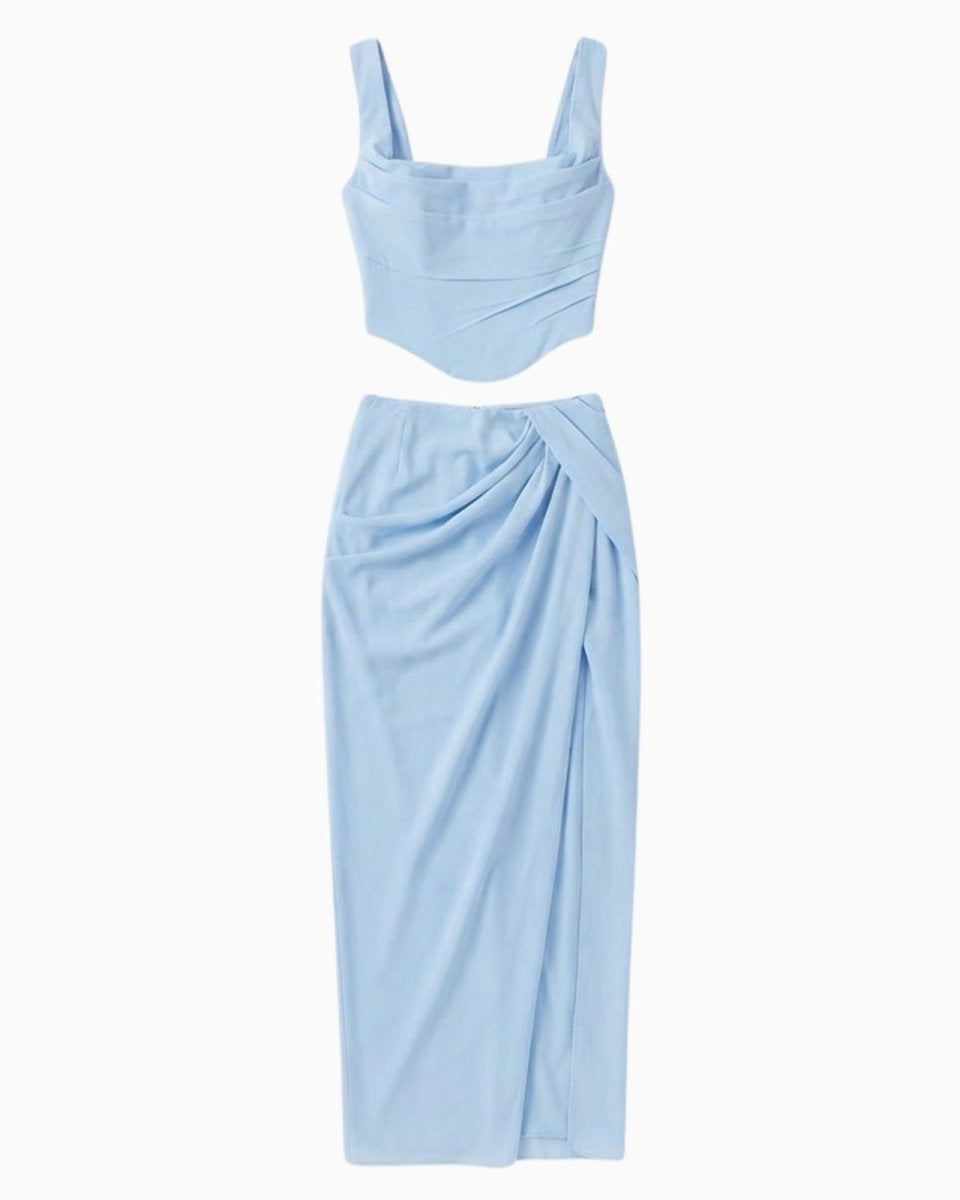 Flat lay of the light blue co-ord set, showing the front of the corset top and draped midi skirt