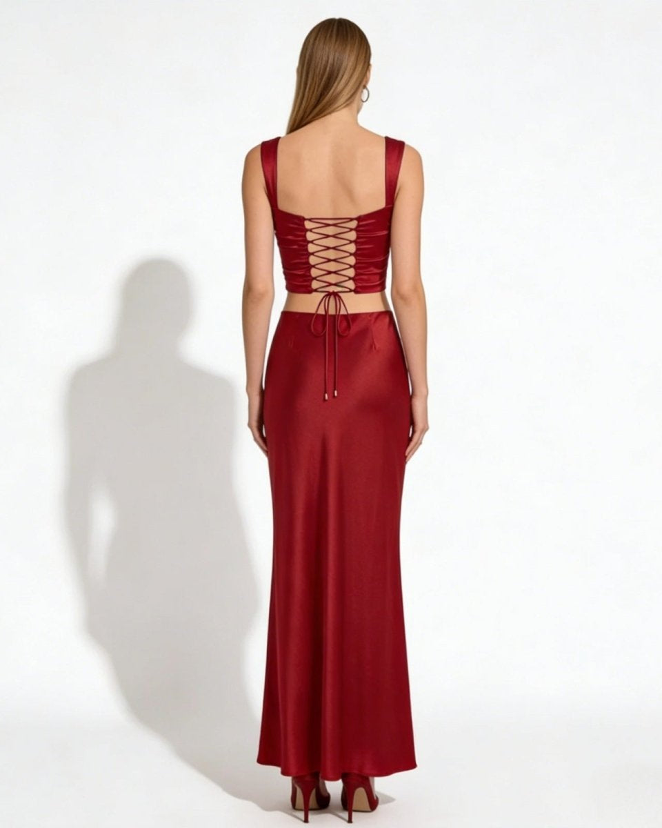 Back view of the Rona red satin crop top, detailing the adjustable corset-style lace-up design and matching high-waisted maxi skirt.