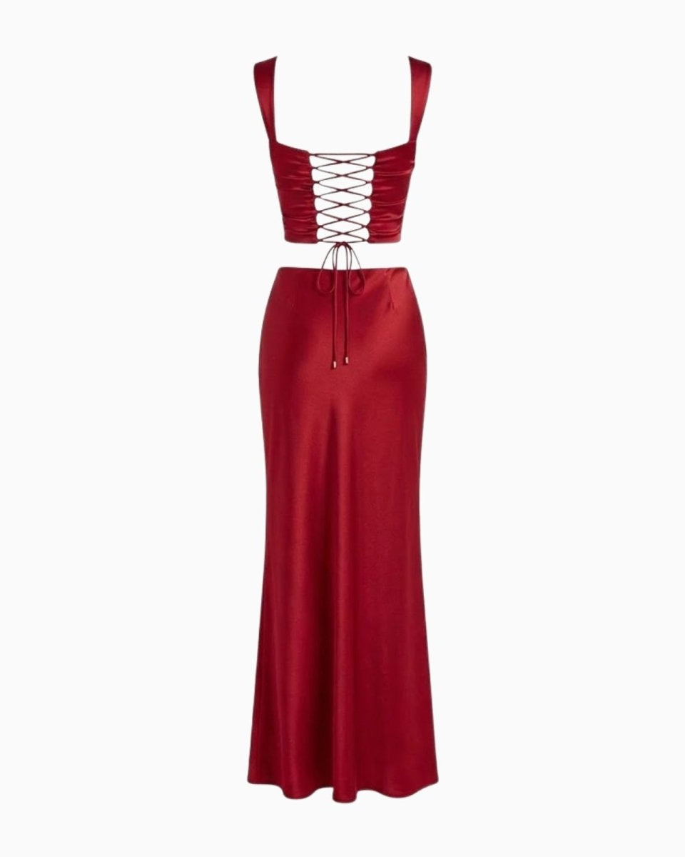 Flat lay of the Rona set in red satin, showing the back of the top with its corset lacing and the full length of the skirt.