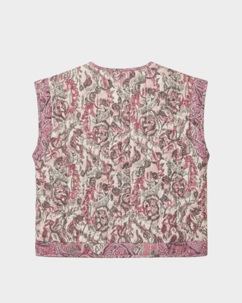 Flat lay product photograph of the back of the Rose quilted vest, showing the full scope of the artisanal paisley and floral jacquard fabric.