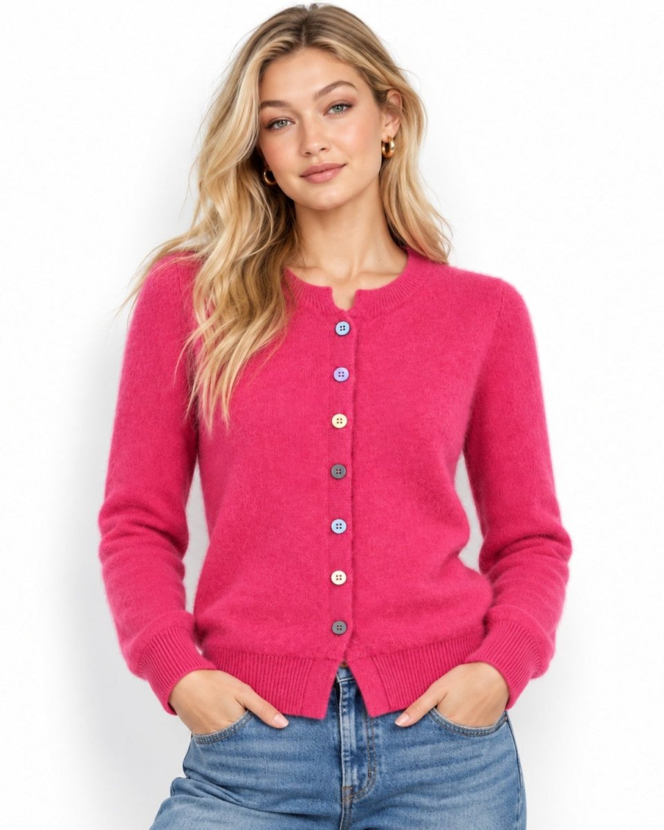 Blonde model wearing women's luxury brushed knit crewneck cardigan sweater in vibrant fuchsia pink with jeans.