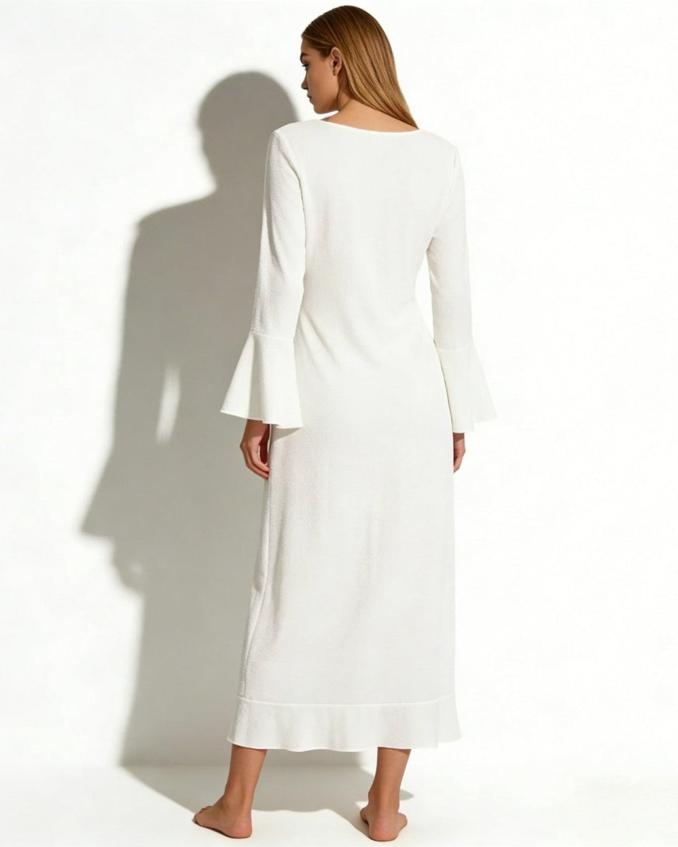 Back view of a woman wearing the Roseta white bell sleeve maxi cover up, highlighting the clean lines and sleeve shape.