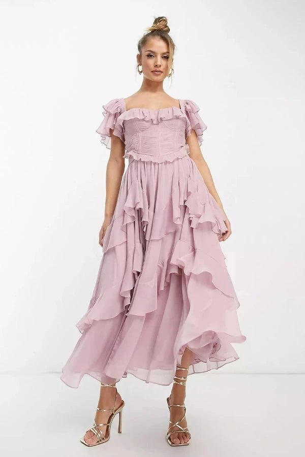 Model wearing Fenlo Form Freyna dusty lilac two-piece ruffle dress with corset top and tiered midi skirt