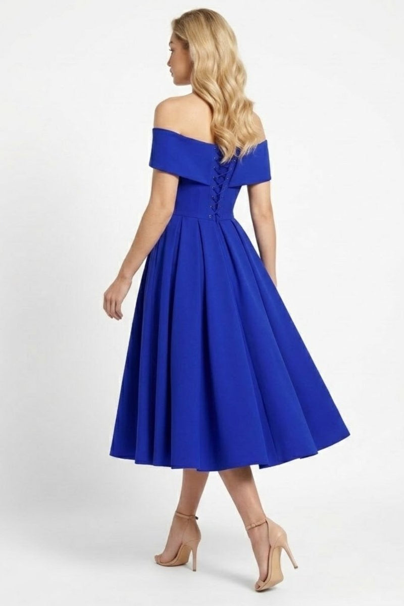 Back view of blue midi dress featuring corset lace up detail and pleated skirt