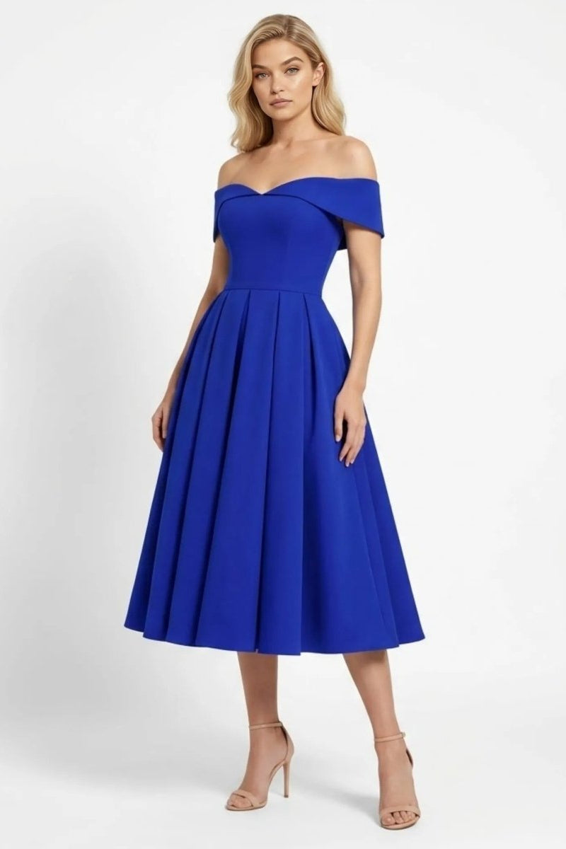 Woman modeling a sapphire blue off the shoulder pleated midi dress by Fenlo Form