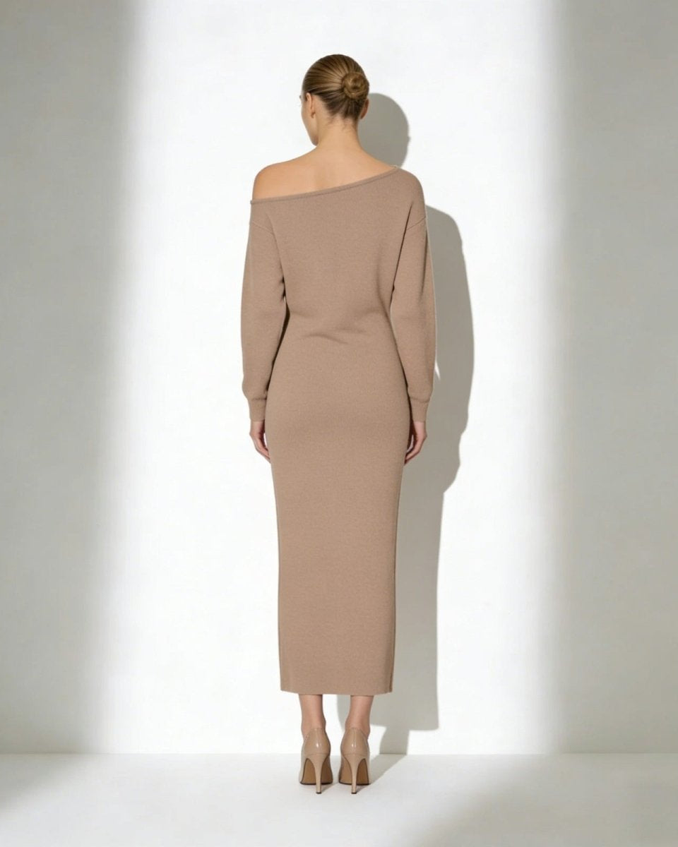 Model seen from the back wearing the Selena asymmetrical knit midi dress in camel.