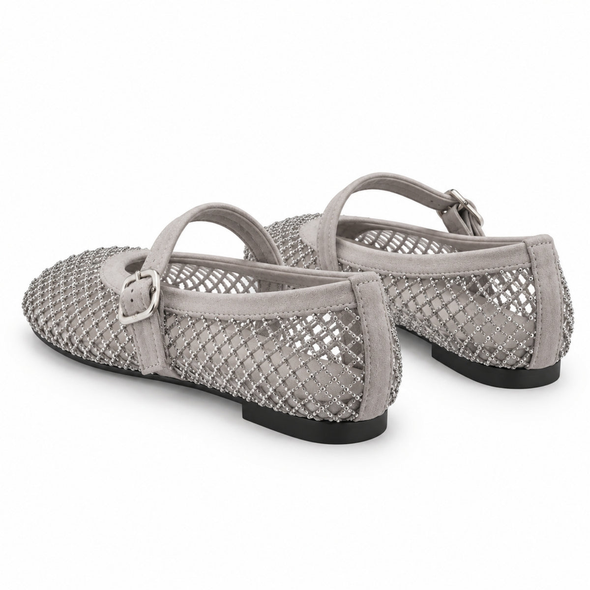 A pair of women's flat shoes in a light gray suede and mesh material, decorated with silver rhinestone trim and featuring adjustable ankle straps with silver buckles, shown against a plain white background.