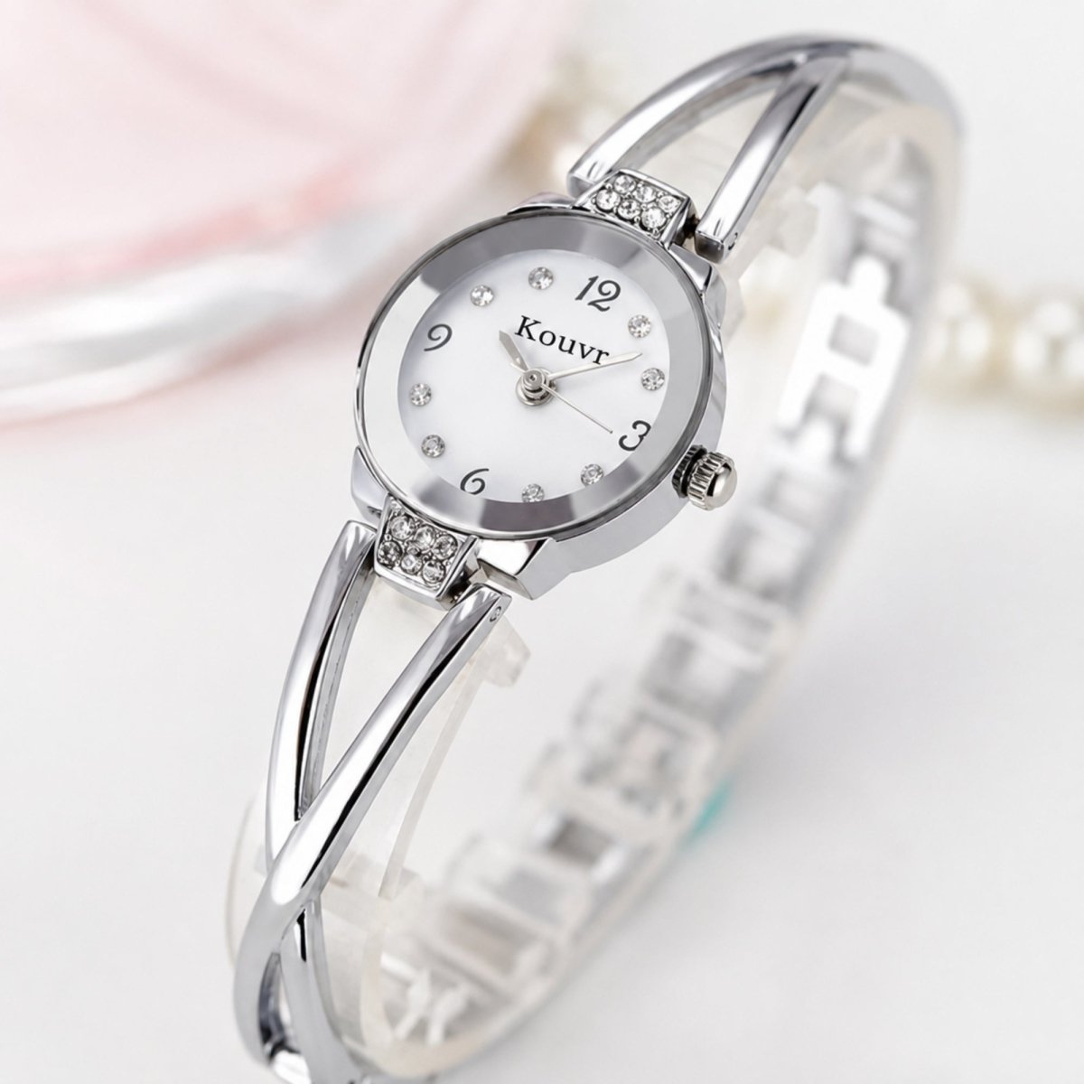 High resolution macro detail of the Kouvr silver women's watch showcasing the precision quartz dial and sparkling crystal hour markers.
