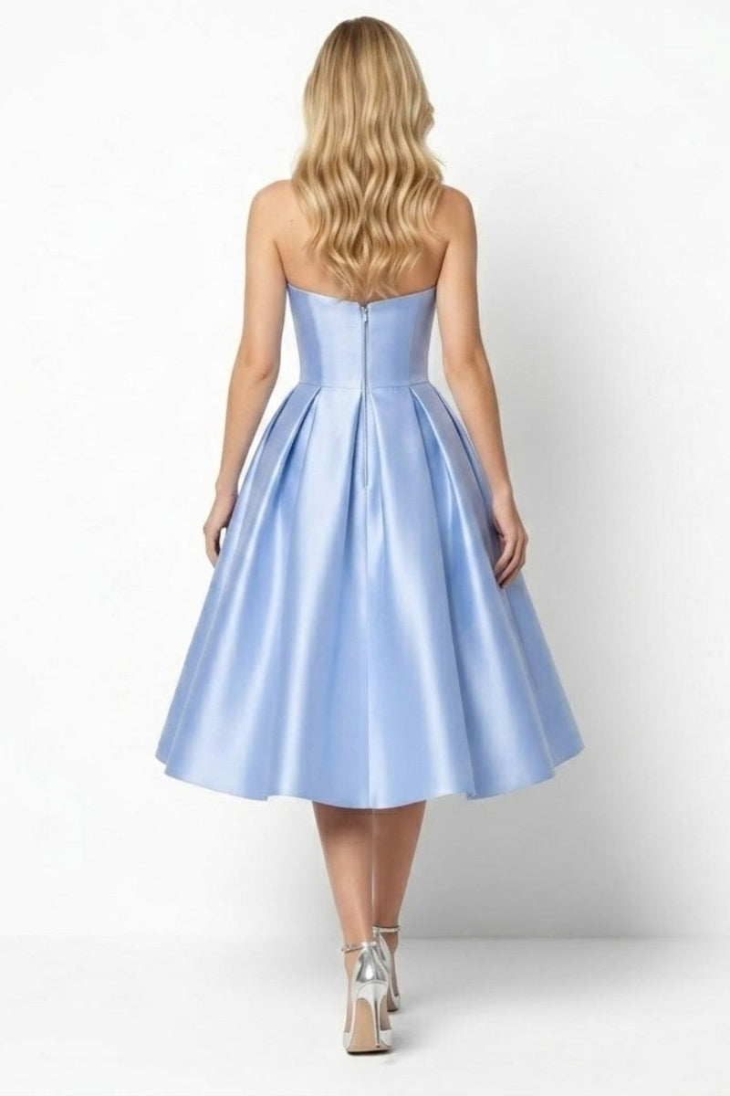 Back view of the sky blue strapless event gown featuring invisible zipper and elegant pleated back skirt details