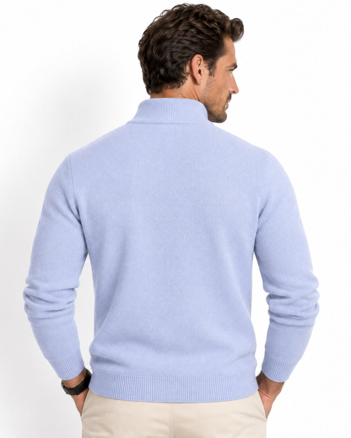 A man shown from the back wearing a sky blue knit mock-neck sweater and beige trousers, photographed against a clean white studio background.