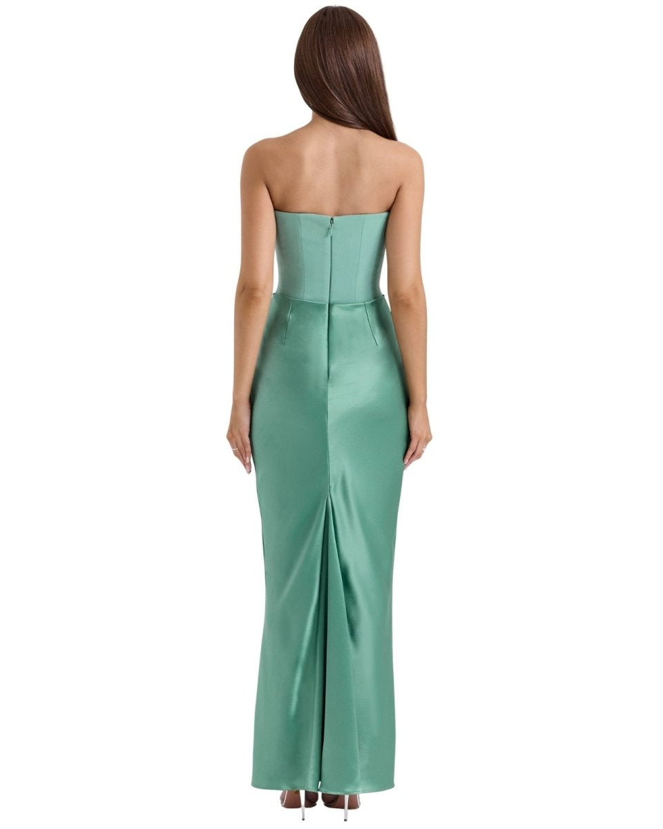 Woman wearing a strapless green evening gown on a white background