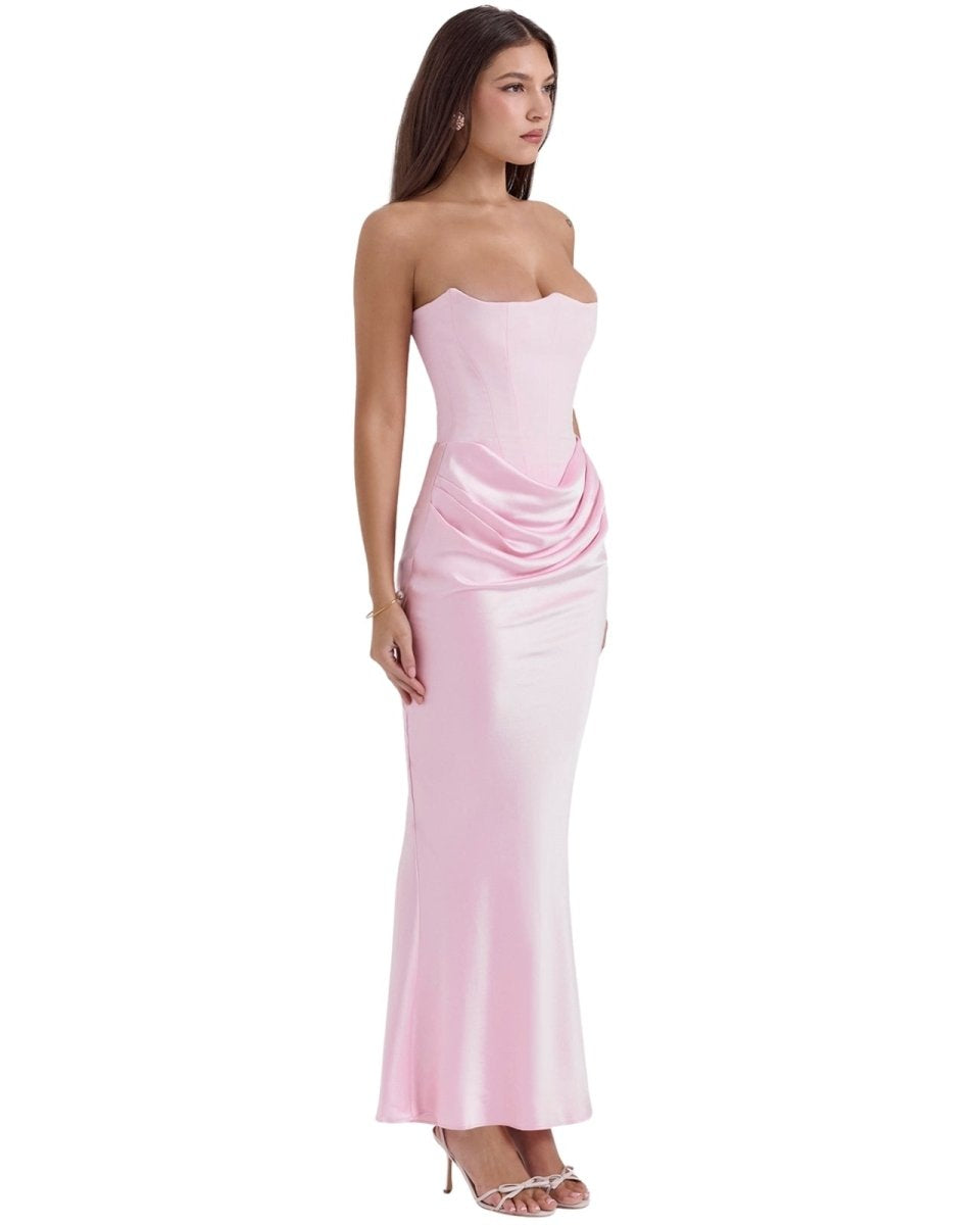 Woman wearing a strapless pink evening gown on a white background