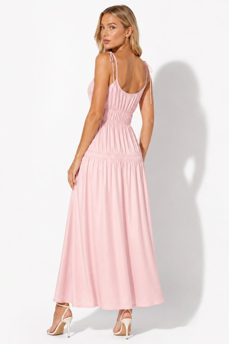 Back view of light pink tiered maxi dress highlighting delicate adjustable tie straps