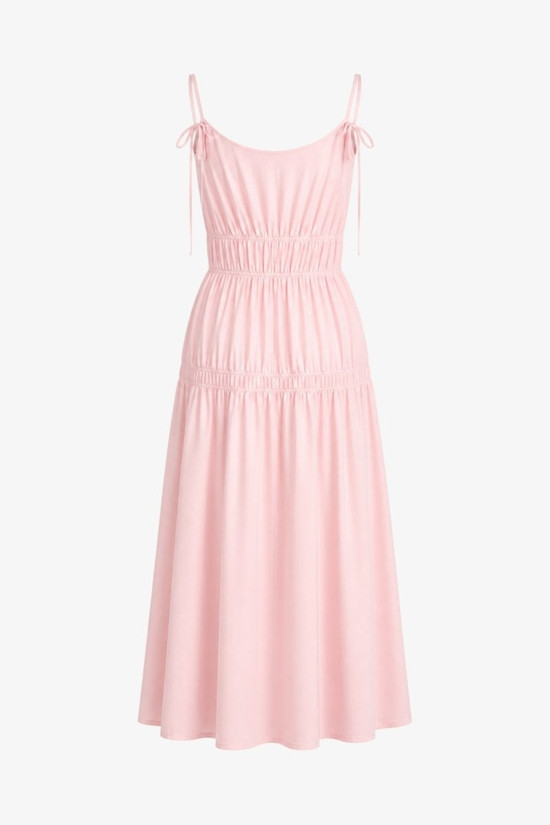 Flat lay back view of light pink tie strap tiered summer gown