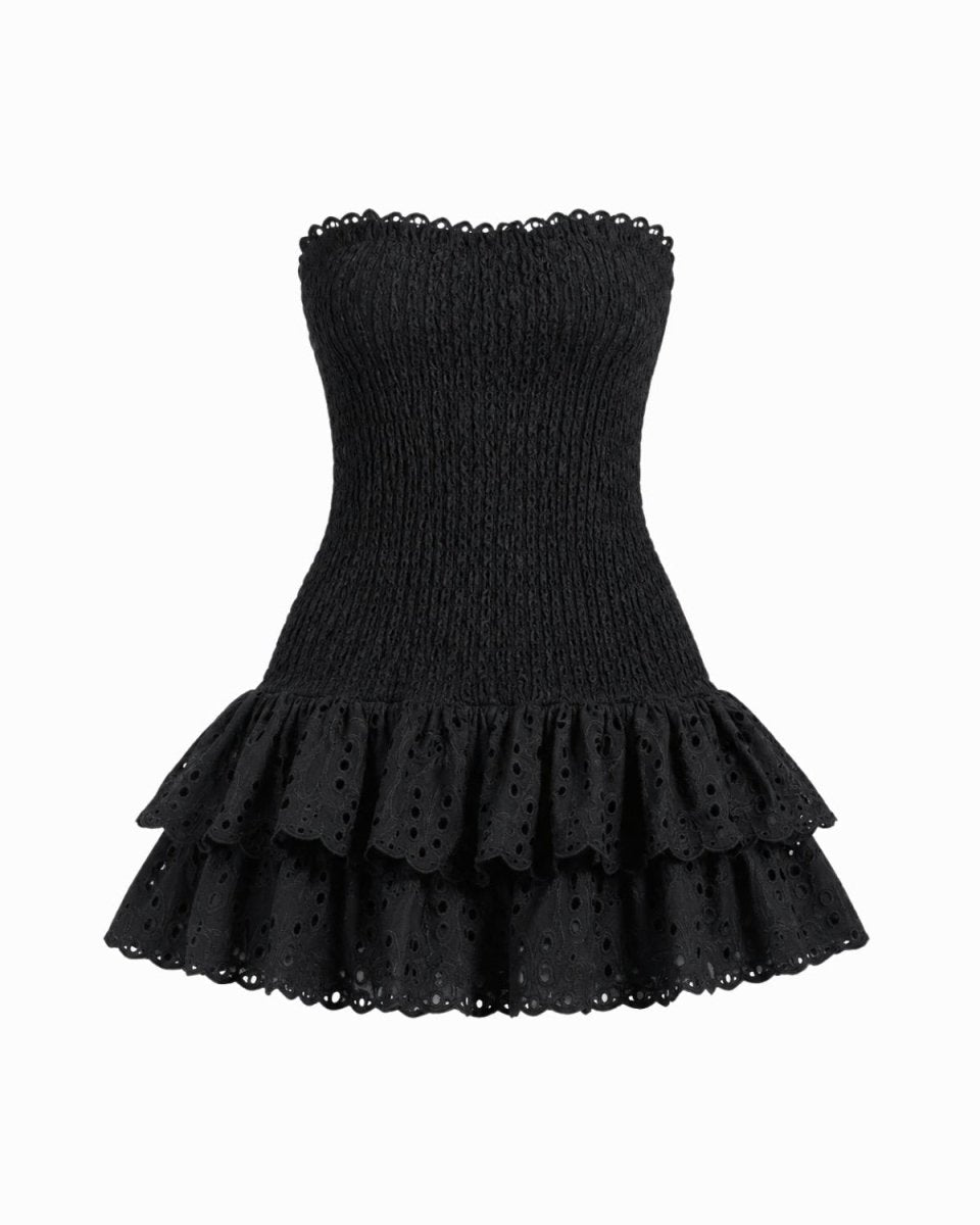 A black strapless eyelet mini dress with a smocked bodice and tiered ruffle skirt, shown against a plain white background.