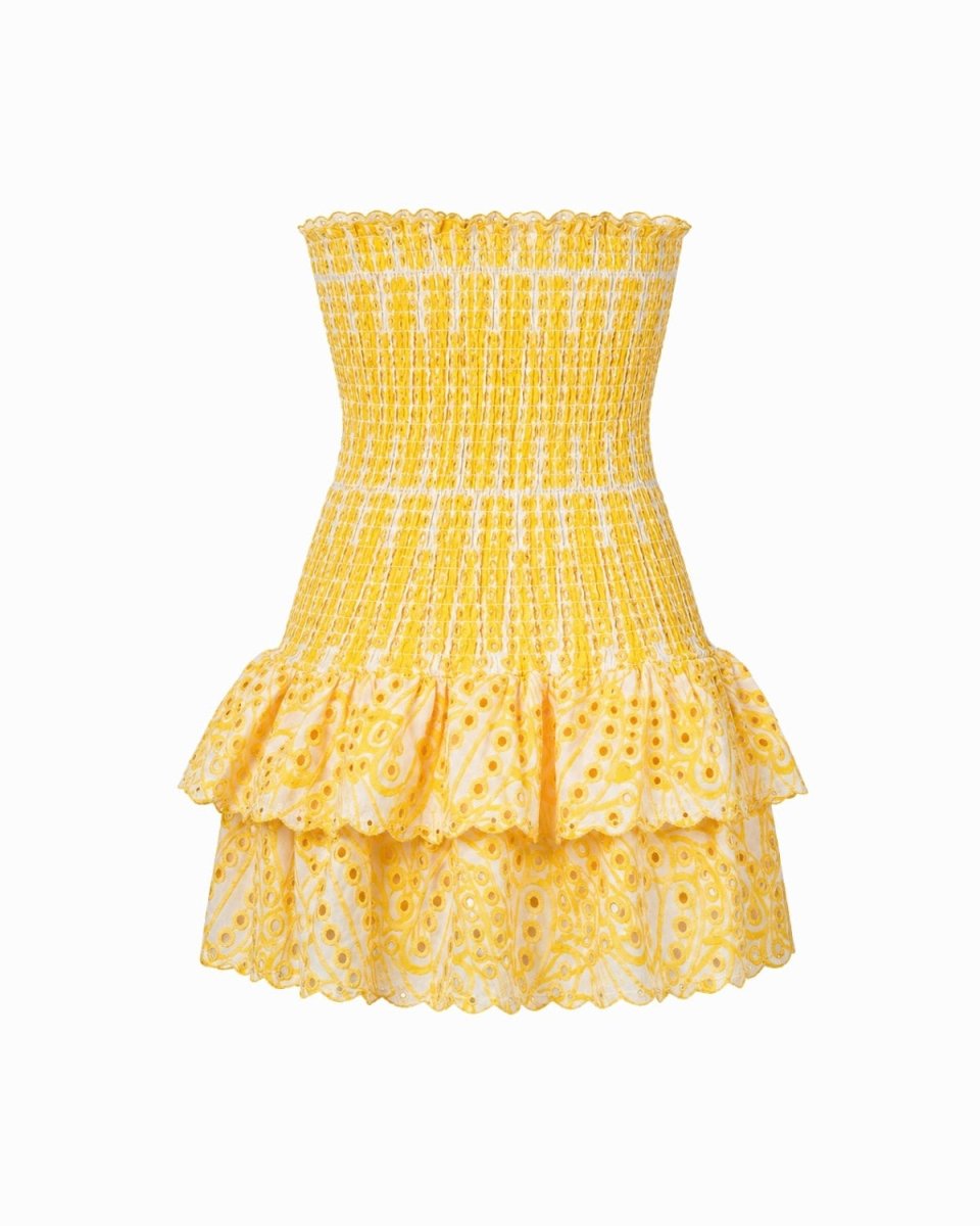 A yellow and white patterned strapless mini dress with a smocked bodice and tiered ruffle skirt, shown against a plain white background.