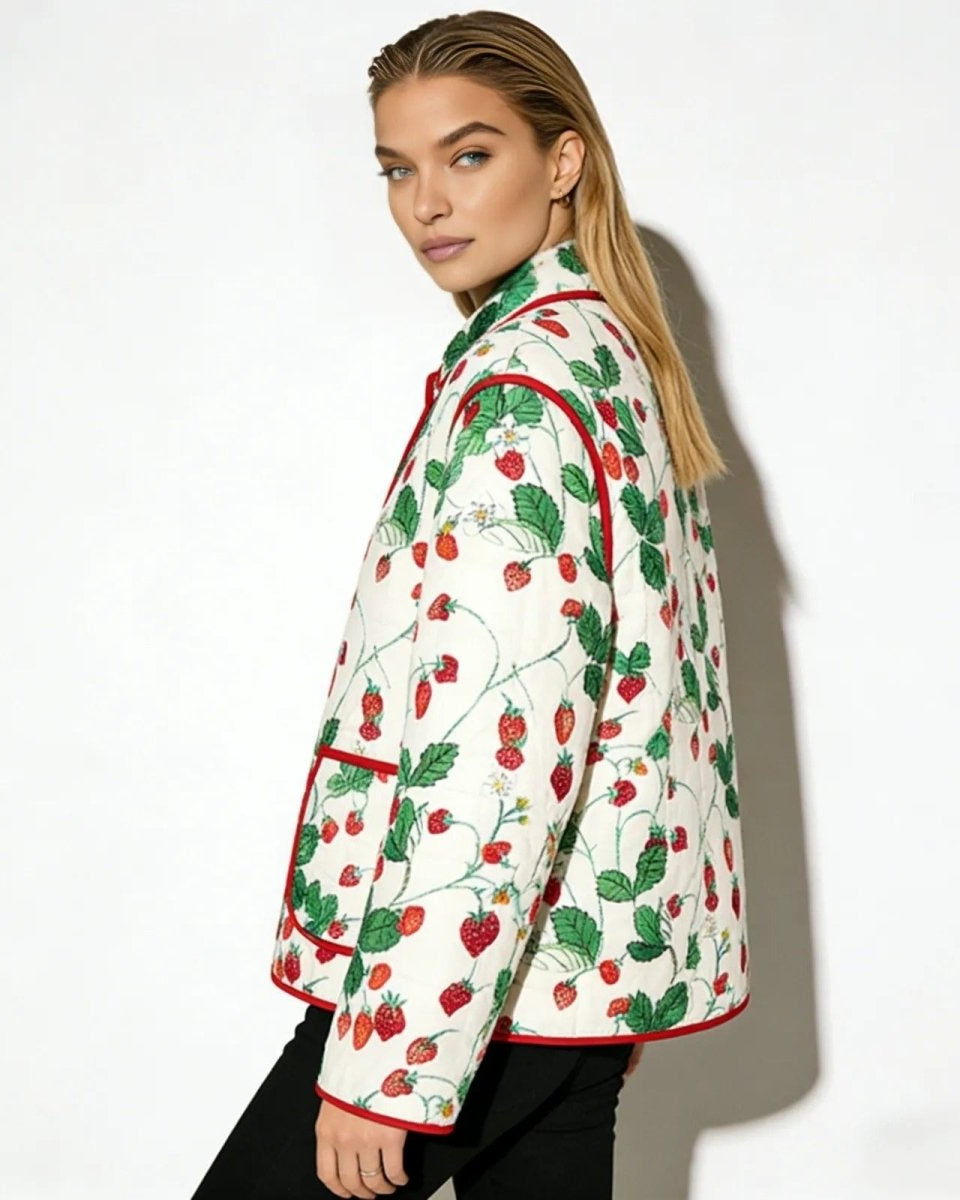 Side profile of a model wearing the white and red strawberry print quilted jacket, showcasing its fit and sleeve detail.
