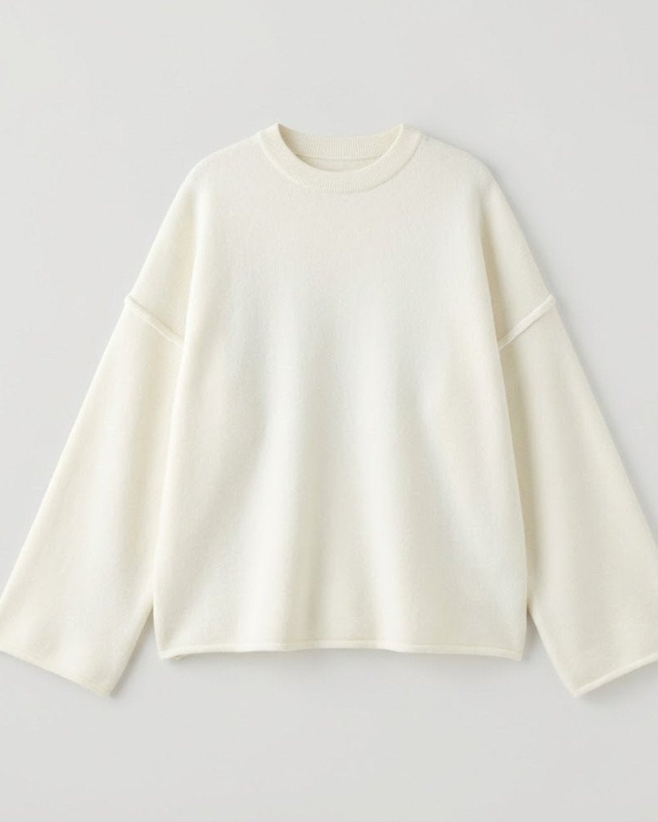 Flat lay of the Krystal sweater in ivory, displaying the mock neckline, external seams, and luxurious soft knit texture on a white surface.