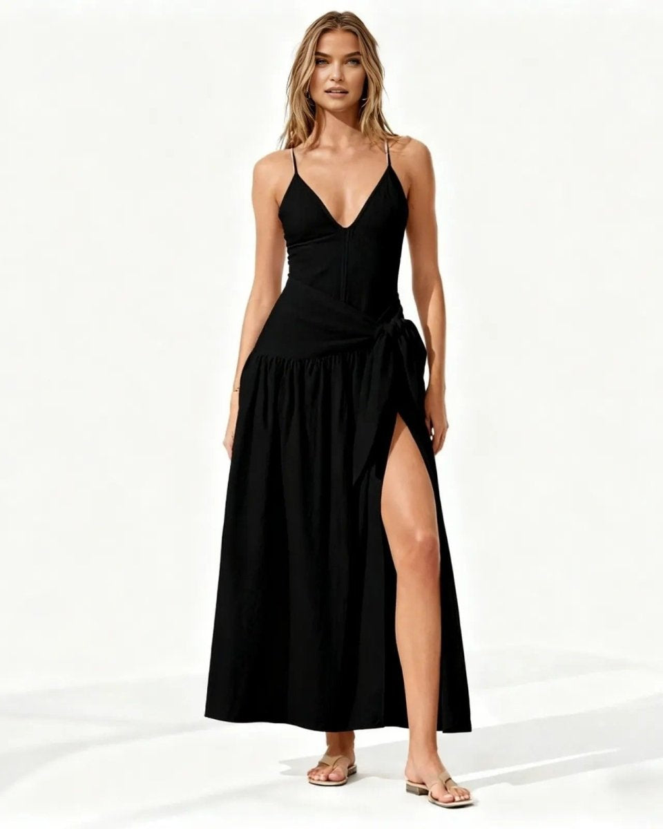 Woman wearing a black dress with a slit on a white background