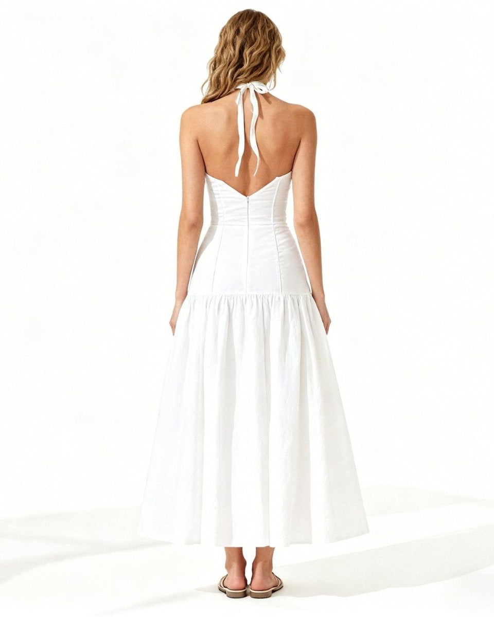 Woman wearing a white halter neck dress on a white background