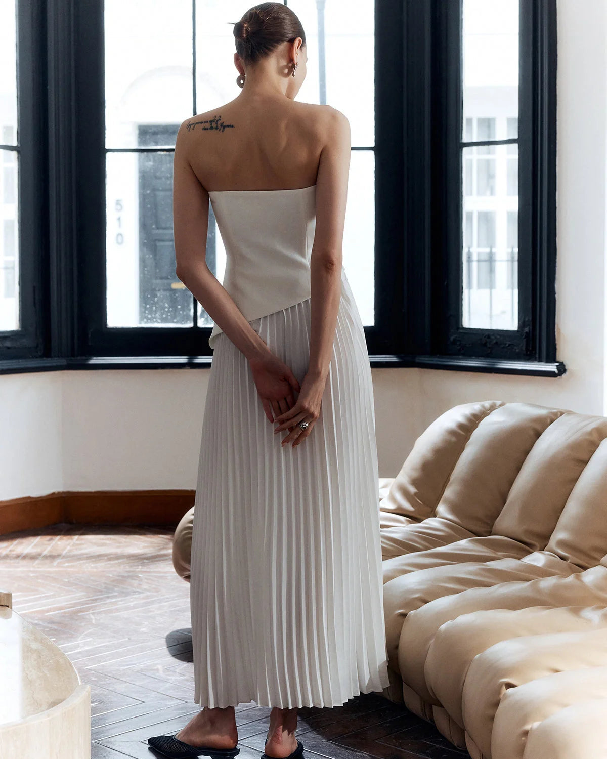 architectural," "sculptural," "asymmetrical," "bonded crepe," and "sunray pleats