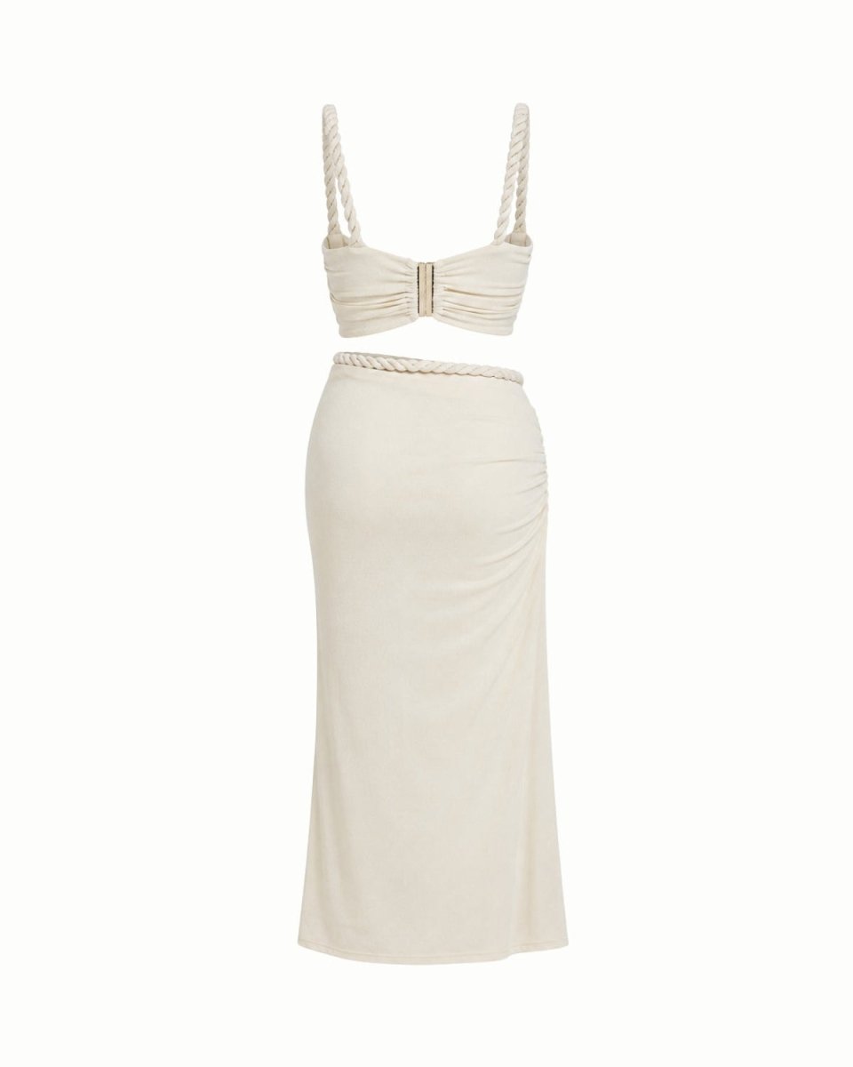 An off-white two-piece set featuring a ruched bandeau top with rope-style straps and a matching high-waisted pencil skirt, displayed on a clean white background.