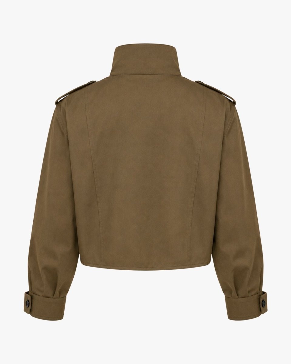 Studio shot back view of structured green cropped jacket showing premium fabric drape and utilitarian shoulder detailing.