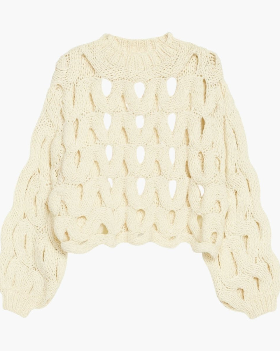 Flat lay of the ivory Vanice open-knit sweater, showing the full design and texture.