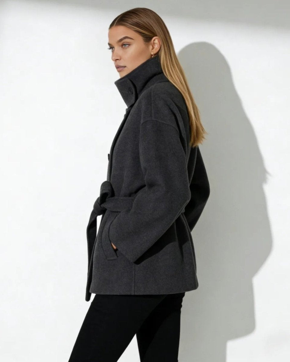 Side profile of the Verna short wool coat showing its silhouette and high collar detail.