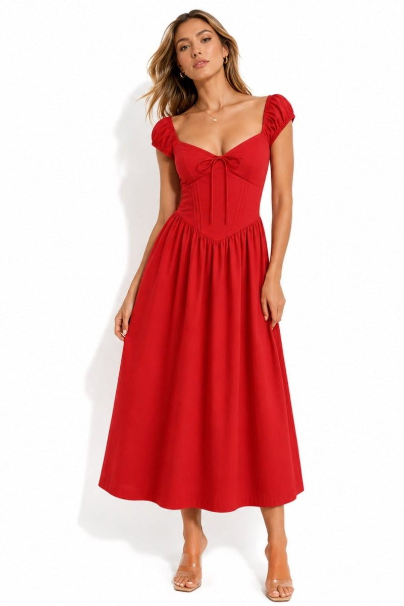 Woman wearing vibrant solid red A-line midi dress with cap sleeves and tie front bust