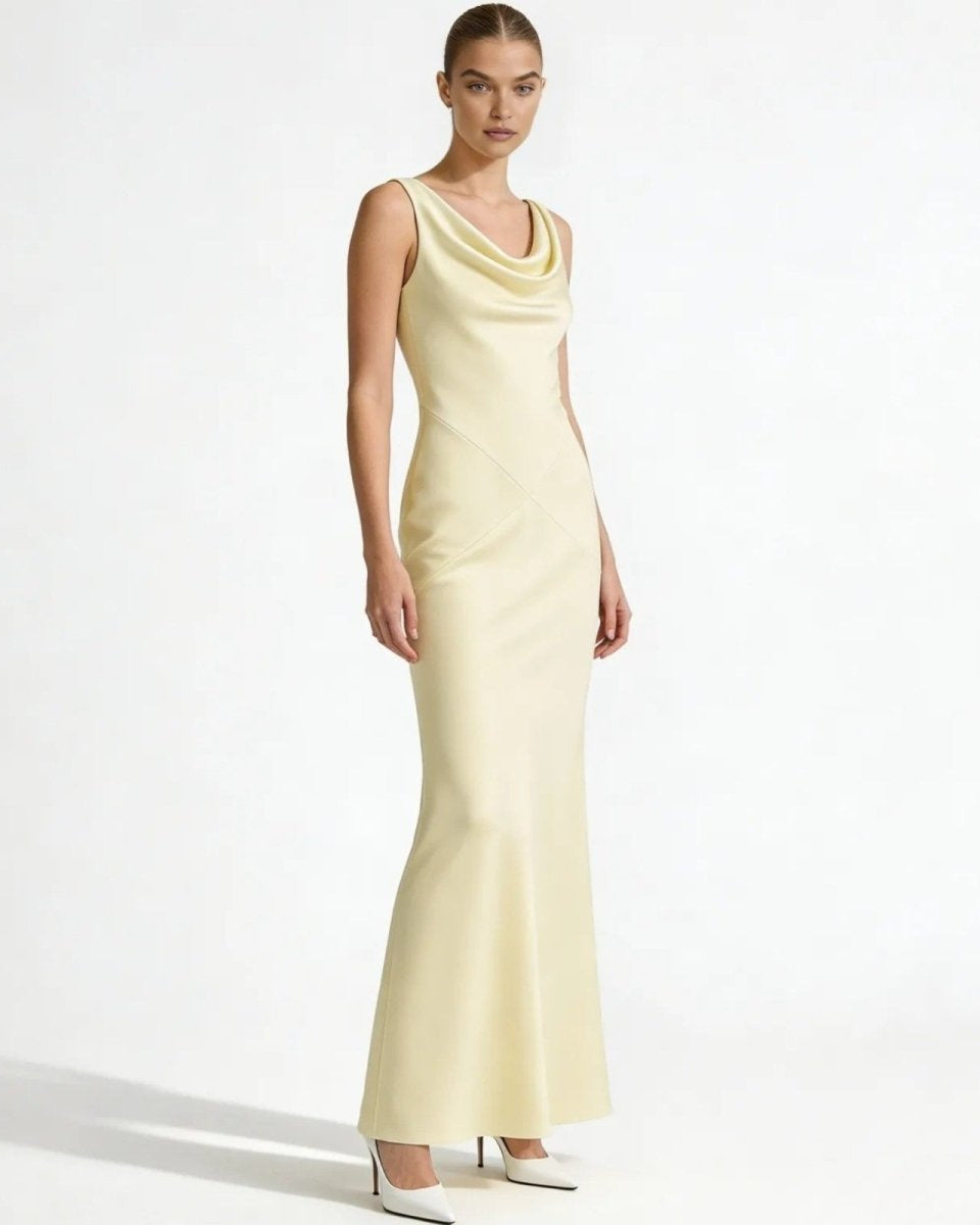 Model wearing the Vickie Gown in Ivory, a sleeveless cowl neck satin maxi dress, viewed from the front against a white background.